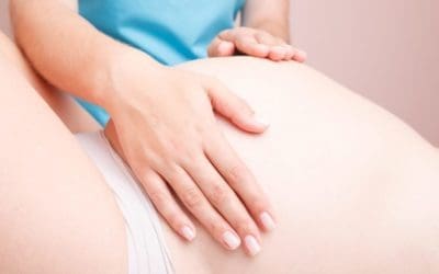 Pregnant woman receiving osteopathic treatment of her belly