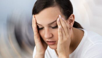 Woman Suffering From Headache Dizziness